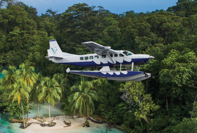 An Elevair seaplane flying over a Panama island..